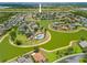 Aerial view of a community with a lake, pool, and well-maintained landscaping at 2747 Suncoast Lakes Blvd, Punta Gorda, FL 33980