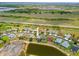 Aerial view of a home with a pool, lake, and well-maintained landscaping at 2747 Suncoast Lakes Blvd, Punta Gorda, FL 33980