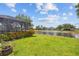 Lush green lawn leads to a lake view from the screened lanai at 2747 Suncoast Lakes Blvd, Punta Gorda, FL 33980