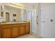 Bright bathroom featuring a double sink vanity with a glass-enclosed shower at 2747 Suncoast Lakes Blvd, Punta Gorda, FL 33980