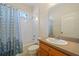 Bathroom featuring a tub/shower combo with a patterned curtain and a single sink vanity at 2747 Suncoast Lakes Blvd, Punta Gorda, FL 33980