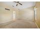 Large bedroom with carpet and a ceiling fan, also features an en-suite bathroom at 2747 Suncoast Lakes Blvd, Punta Gorda, FL 33980