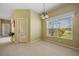 Sunlit dining area with views of the pool and lanai through a sliding glass door at 2747 Suncoast Lakes Blvd, Punta Gorda, FL 33980