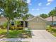 Charming single-story home featuring a two-car garage and lush landscaping, creating a welcoming curb appeal at 2747 Suncoast Lakes Blvd, Punta Gorda, FL 33980