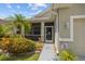Charming home with screened porch, complemented by vibrant landscaping, offering a cozy and inviting entrance at 2747 Suncoast Lakes Blvd, Punta Gorda, FL 33980
