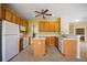 Spacious kitchen boasts wood cabinets, a central island, and modern appliances, perfect for culinary enthusiasts at 2747 Suncoast Lakes Blvd, Punta Gorda, FL 33980