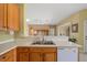 Kitchen sink and counter area overlooking an additional living space and backyard access at 2747 Suncoast Lakes Blvd, Punta Gorda, FL 33980