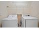 Laundry room featuring a washer, dryer and wire shelving at 2747 Suncoast Lakes Blvd, Punta Gorda, FL 33980