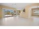 An open concept living space with seamless indoor-outdoor flow, showcasing a bright kitchen and dining area at 2747 Suncoast Lakes Blvd, Punta Gorda, FL 33980