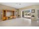 Spacious living room boasts neutral tones, tile floors, and sliding doors that lead to a serene pool area at 2747 Suncoast Lakes Blvd, Punta Gorda, FL 33980