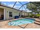 A screened-in pool with blue tile and brick pavers is perfect for a relaxing day at 2747 Suncoast Lakes Blvd, Punta Gorda, FL 33980