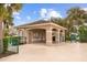 Exterior view of pool house including covered picnic tables and restrooms fenced off for safety at 2747 Suncoast Lakes Blvd, Punta Gorda, FL 33980