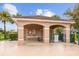 Exterior view of the pool house featuring a shelter with seating, restrooms, and an outdoor shower at 2747 Suncoast Lakes Blvd, Punta Gorda, FL 33980