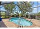 Relaxing screened-in lanai featuring a rejuvenating spa, perfect for unwinding amidst a private outdoor setting at 2747 Suncoast Lakes Blvd, Punta Gorda, FL 33980