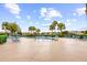 Wide view of the community pool with lounge chairs and umbrellas on a sunny day at 2747 Suncoast Lakes Blvd, Punta Gorda, FL 33980