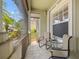 Relaxing screened porch, furnished with comfortable chairs, inviting a peaceful retreat within the home's serene ambiance at 2747 Suncoast Lakes Blvd, Punta Gorda, FL 33980
