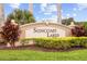 Suncoast Lakes neighborhood sign with lush landscaping at 2747 Suncoast Lakes Blvd, Punta Gorda, FL 33980