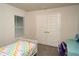View of a bedroom with decor and a grey carpet, white trim, window with blinds and a colorful bed set at 2858 Parlay Ln, North Port, FL 34286