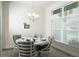 Elegant dining room featuring a modern chandelier, a large window, and comfortable seating for formal gatherings at 2858 Parlay Ln, North Port, FL 34286