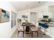 Bright dining room with modern decor and a view into the open concept kitchen, perfect for entertaining at 2858 Parlay Ln, North Port, FL 34286