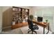 Inviting home office providing a functional workspace with a bookshelf and a comfortable chair at 2858 Parlay Ln, North Port, FL 34286