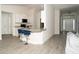 Open-concept kitchen and bar area featuring stone countertops, white cabinetry, and an inviting seating area at 2858 Parlay Ln, North Port, FL 34286