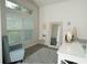 This bright living room has a reading chair, a mirror and a desk with a lamp and nice flooring at 2858 Parlay Ln, North Port, FL 34286