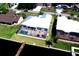 Aerial view of a home with a screened in pool, waterway access, and a wooden dock at 3772 Peace River Dr, Punta Gorda, FL 33983