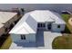 Aerial view of a bright blue waterfront home featuring a metal roof and convenient circular driveway at 3772 Peace River Dr, Punta Gorda, FL 33983