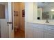 Bathroom featuring double sink and adjacent water closet with toilet and shower at 3772 Peace River Dr, Punta Gorda, FL 33983