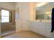 Bathroom featuring double sink, large mirror, separate toilet and walk in shower at 3772 Peace River Dr, Punta Gorda, FL 33983