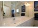 Bathroom boasts a dual sink vanity with ample counter space, bright lighting, and framed mirror at 3772 Peace River Dr, Punta Gorda, FL 33983