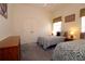 Bright bedroom featuring two twin beds, neutral walls, and a double door closet at 3772 Peace River Dr, Punta Gorda, FL 33983