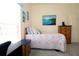 Bedroom featuring daybed, desk, and a window with blinds at 3772 Peace River Dr, Punta Gorda, FL 33983