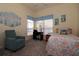 Bedroom featuring daybed, desk with reading chair, and a window with blinds at 3772 Peace River Dr, Punta Gorda, FL 33983