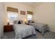 Well-lit bedroom showcases twin beds, bedside tables with lamps, and carpeted floors at 3772 Peace River Dr, Punta Gorda, FL 33983