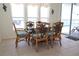 Dining room with lake view, glass top table, and seating for six in a bright and sunny space at 3772 Peace River Dr, Punta Gorda, FL 33983