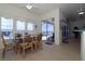 Bright dining area with lake view, tile floors, and sliding glass doors to the pool area at 3772 Peace River Dr, Punta Gorda, FL 33983