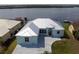Waterfront property with a freshly painted exterior, metal roof, and well-maintained landscaping at 3772 Peace River Dr, Punta Gorda, FL 33983