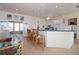 An open concept kitchen with light cabinetry and unique lighting connects seamlessly to an adjacent seating area at 3772 Peace River Dr, Punta Gorda, FL 33983