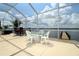 Covered lanai with outdoor dining area offers waterfront views and access to a private dock at 3772 Peace River Dr, Punta Gorda, FL 33983