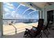 Relax on the screened lanai with a view of the waterfront, dock, and swimming pool at 3772 Peace River Dr, Punta Gorda, FL 33983