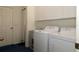 Functional laundry room with a washing machine, dryer, storage cabinets, and a utility sink at 3772 Peace River Dr, Punta Gorda, FL 33983