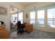 Office space featuring a desk, windows and a slider to screened-in outdoor space and canal view at 3772 Peace River Dr, Punta Gorda, FL 33983