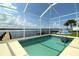 A beautiful screened-in pool area offers water views, a dock, and space for entertaining at 3772 Peace River Dr, Punta Gorda, FL 33983