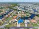 Waterfront home outlined and surrounded by a canal community with a blue metal roof at 3825 Barnegat Dr, Punta Gorda, FL 33950