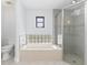 Bright bathroom featuring a shower, tub, and a glass block window at 3825 Barnegat Dr, Punta Gorda, FL 33950