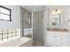 Beautiful bathroom features a glass shower and tub with granite countertop and neutral tile at 3825 Barnegat Dr, Punta Gorda, FL 33950