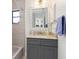 Cozy bathroom boasting a granite countertop, blue vanity, and a shower-tub combination at 3825 Barnegat Dr, Punta Gorda, FL 33950