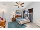 Comfortable primary bedroom with a four-poster bed, ceiling fan, and a view of the outdoors at 3825 Barnegat Dr, Punta Gorda, FL 33950